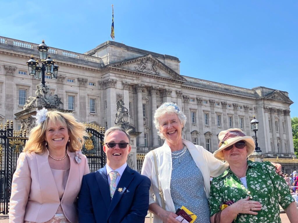 Four Working Together representatives stand outside of Bucking Palace 